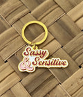 Sassy and Sensitive, Soft Enamel Gold Metal Keychain, 2x1"